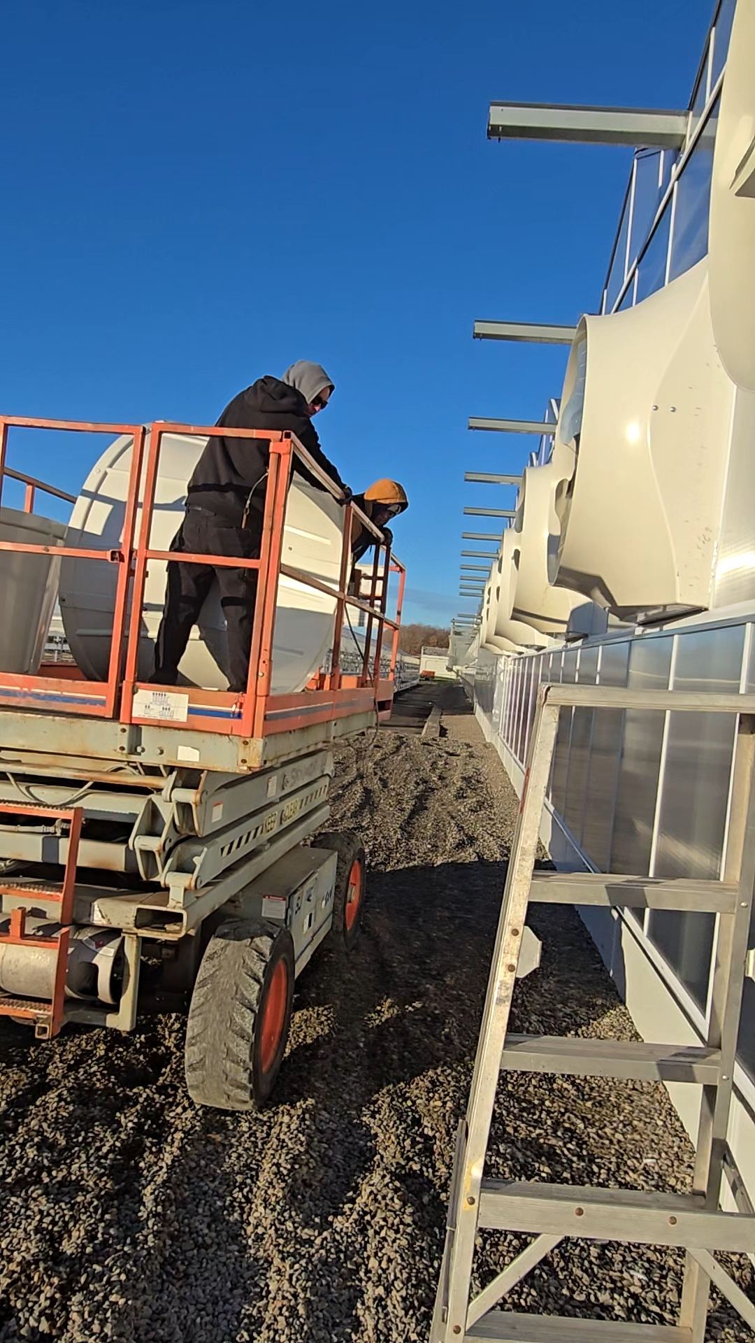 Crew installing exhaust fans on a scissor lift