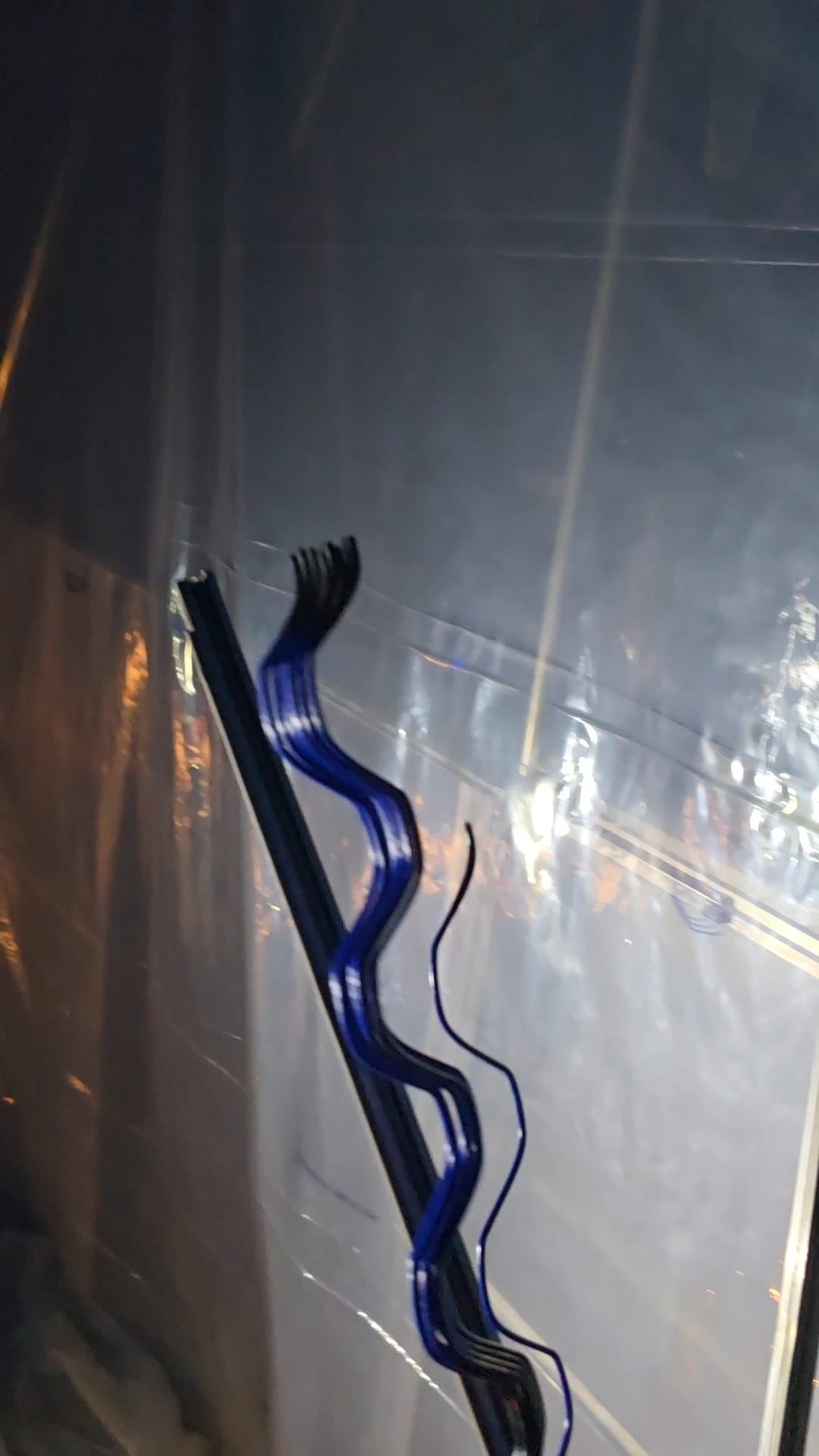Scissor lift positioned at a hoop house during winter conditions